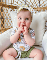 Baby girl is wearing a baby head wrap for little girls from By Bella Boutique.